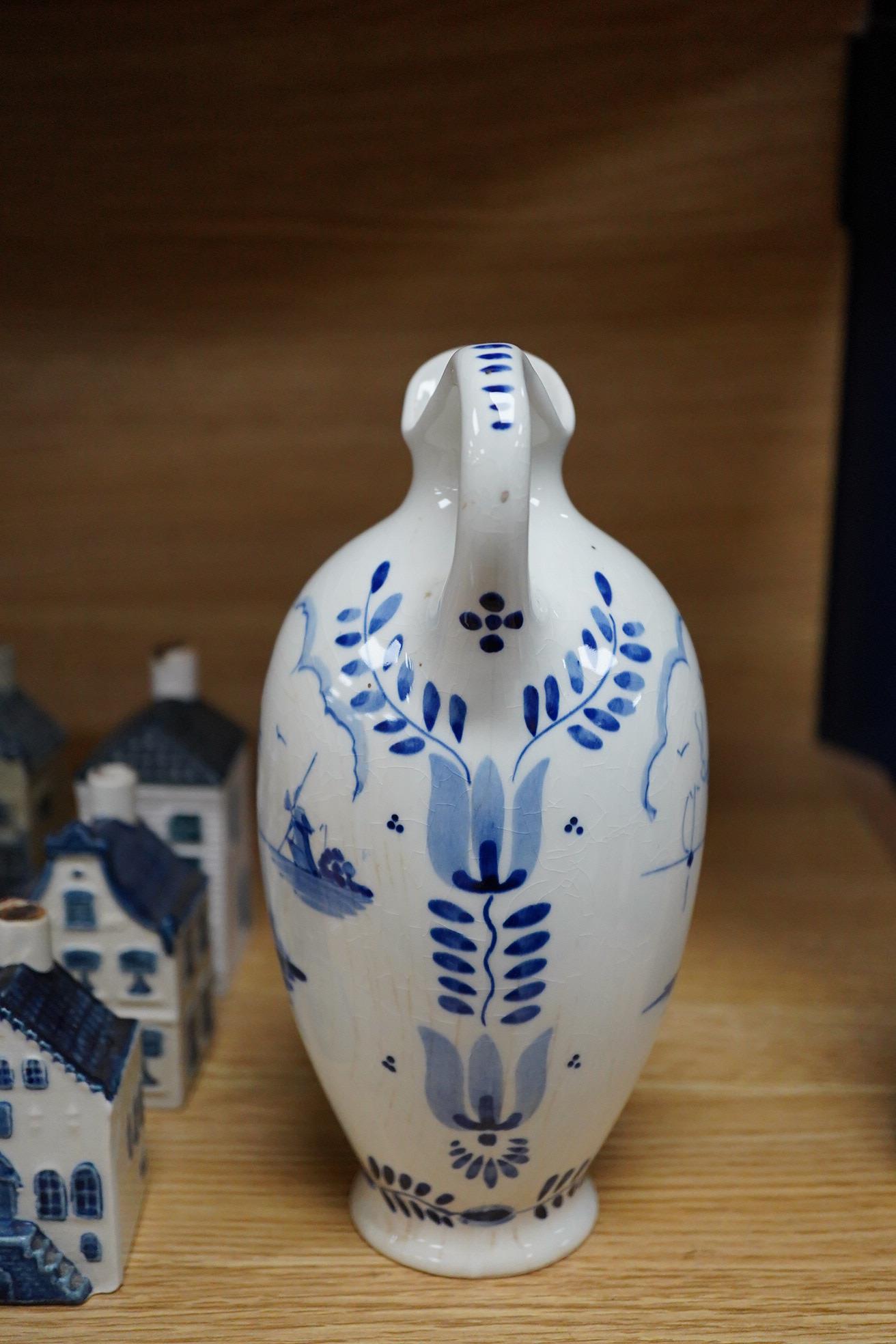 A collection of twenty seven KLM Delft blue miniature houses presented to Business class passengers together with a Delft jug - 20.5cm high